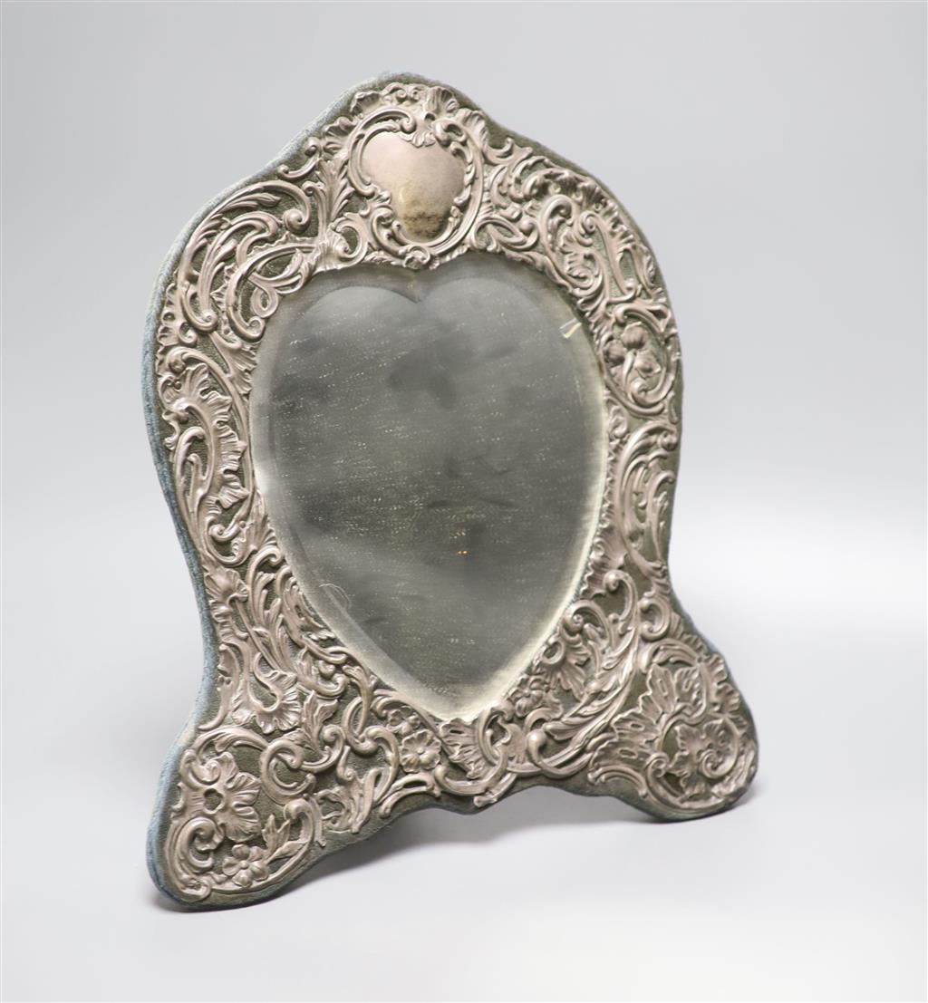 An Edwardian repousse silver mounted shaped easel mirror, Deakin & Francis, Birmingham, 1904, 36cm,